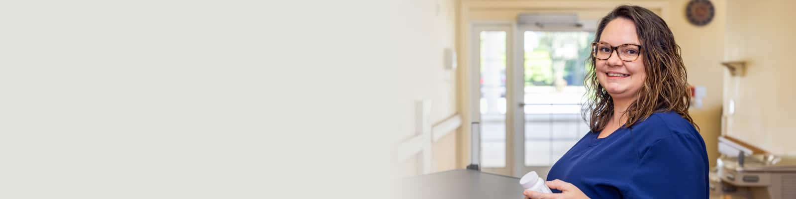 A nurse holding a bottle of pills at Fountain Inn