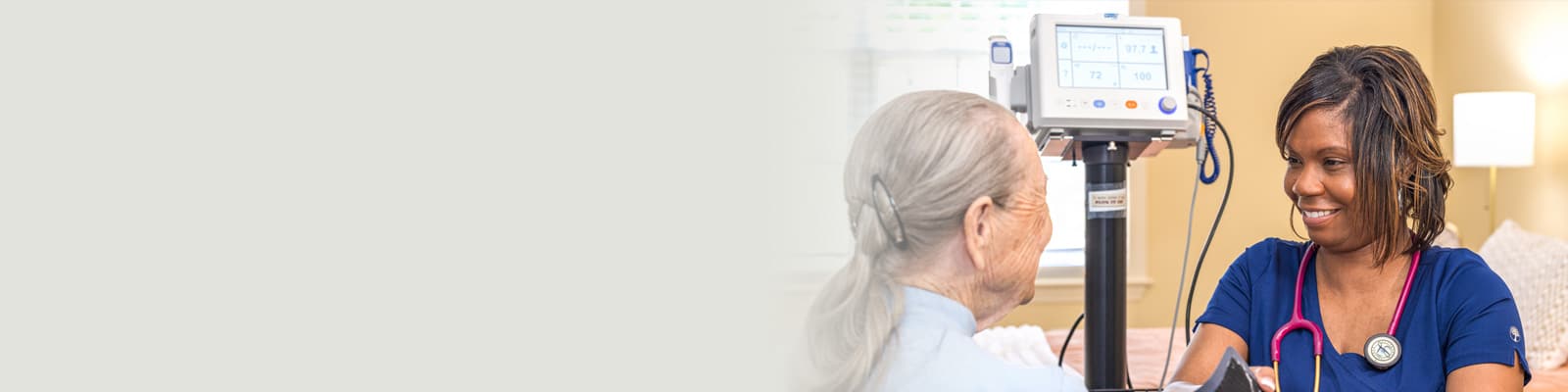 A nurse checking an elderly woman's blood pressure at Fountain Inn