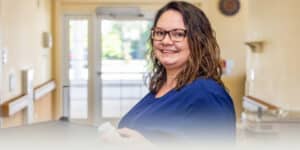 A nurse holding a bottle of pills at Fountain Inn
