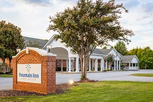 The front of the facility showing a monument sign reading "Fountain Inn"